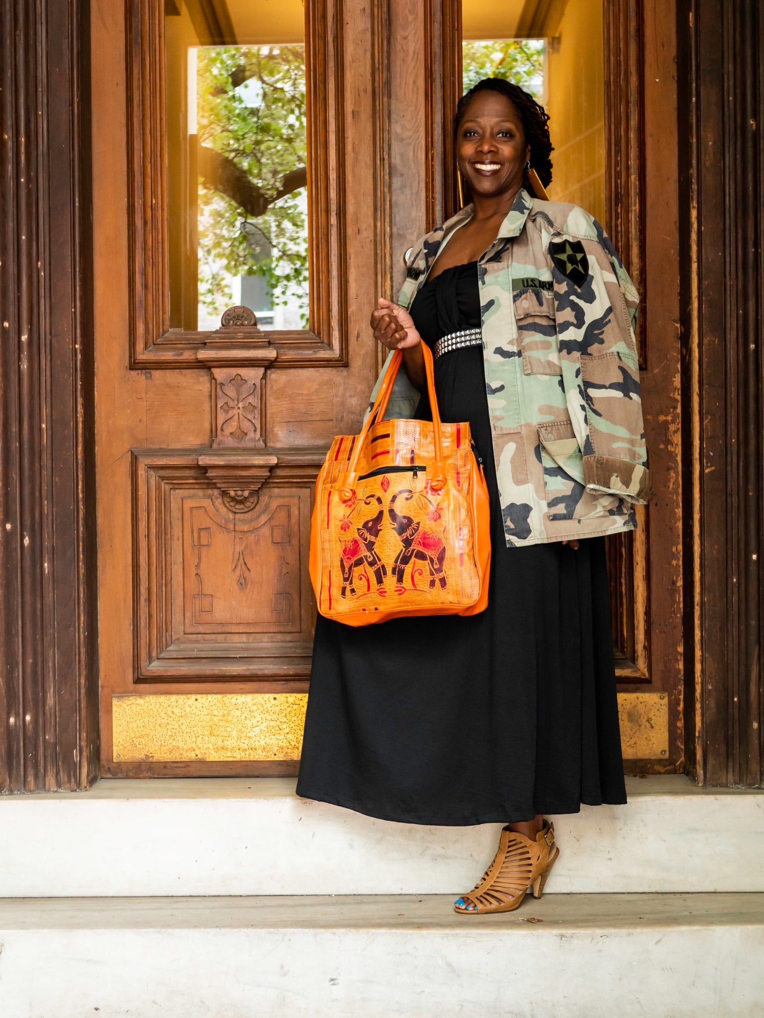 Vintage oversized orange leather handbag with elephants